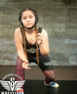 Picture of Hassadah Almanza of Fort Bidwell, CA in her wrestling outfit in a fighting stance